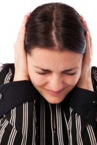 Young businesswoman covering ears with her hands